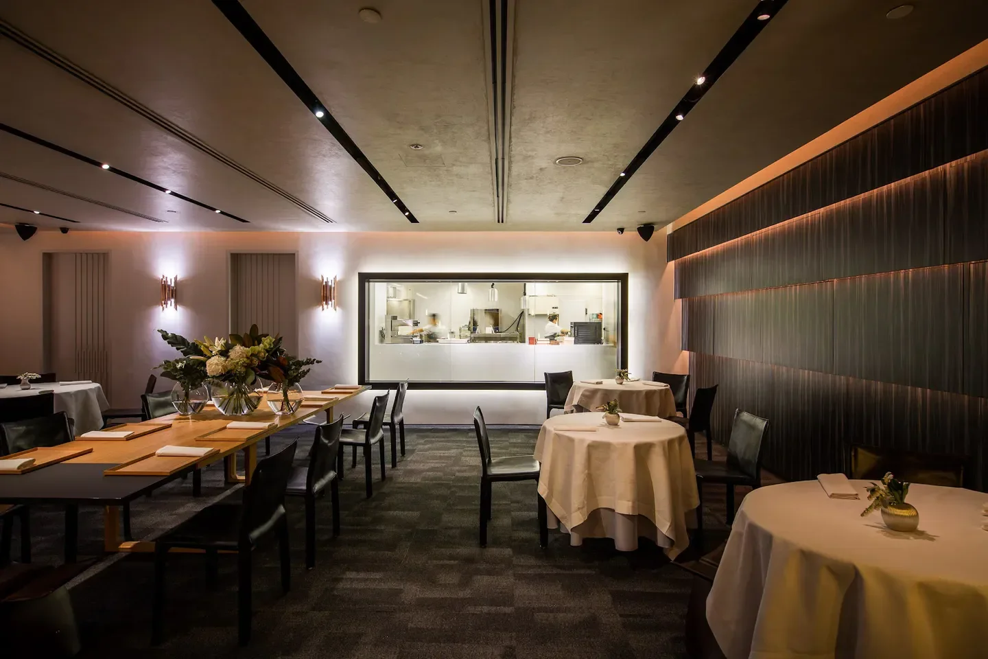Interior of Iggy's in Singapore, featuring dining tables and a view into the kitchen.