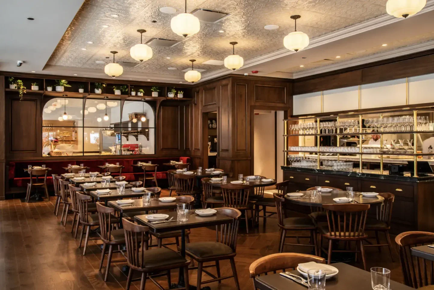 Interior of Il Carciofo restaurant in Chicago, featuring elegant decor and tables.