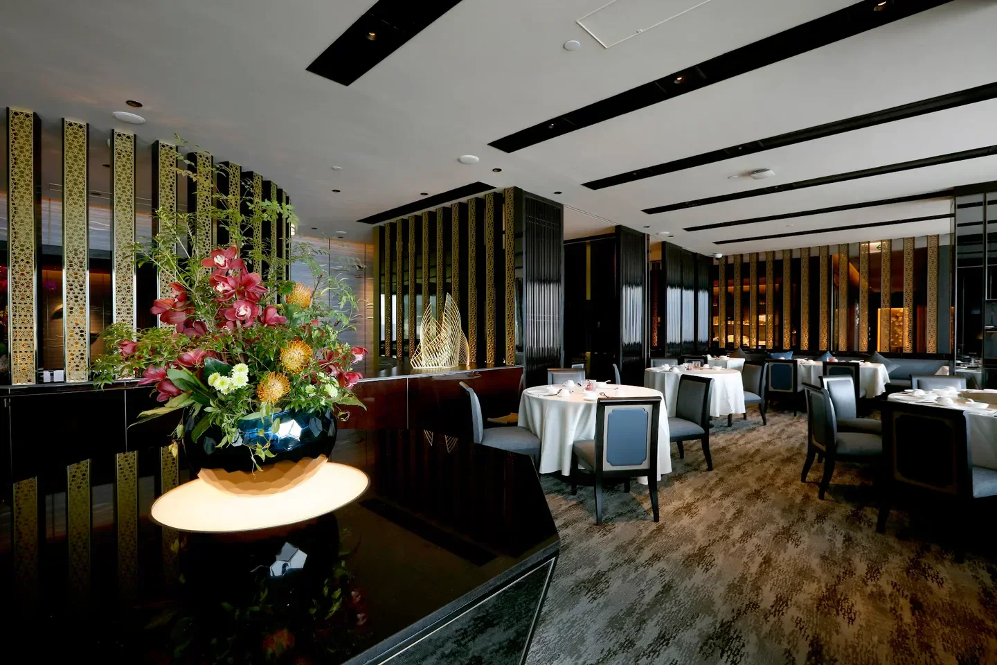 Interior of Imperial Treasure Fine Chinese Cuisine (Tsim Sha Tsui) in Hong Kong, with floral arrangement