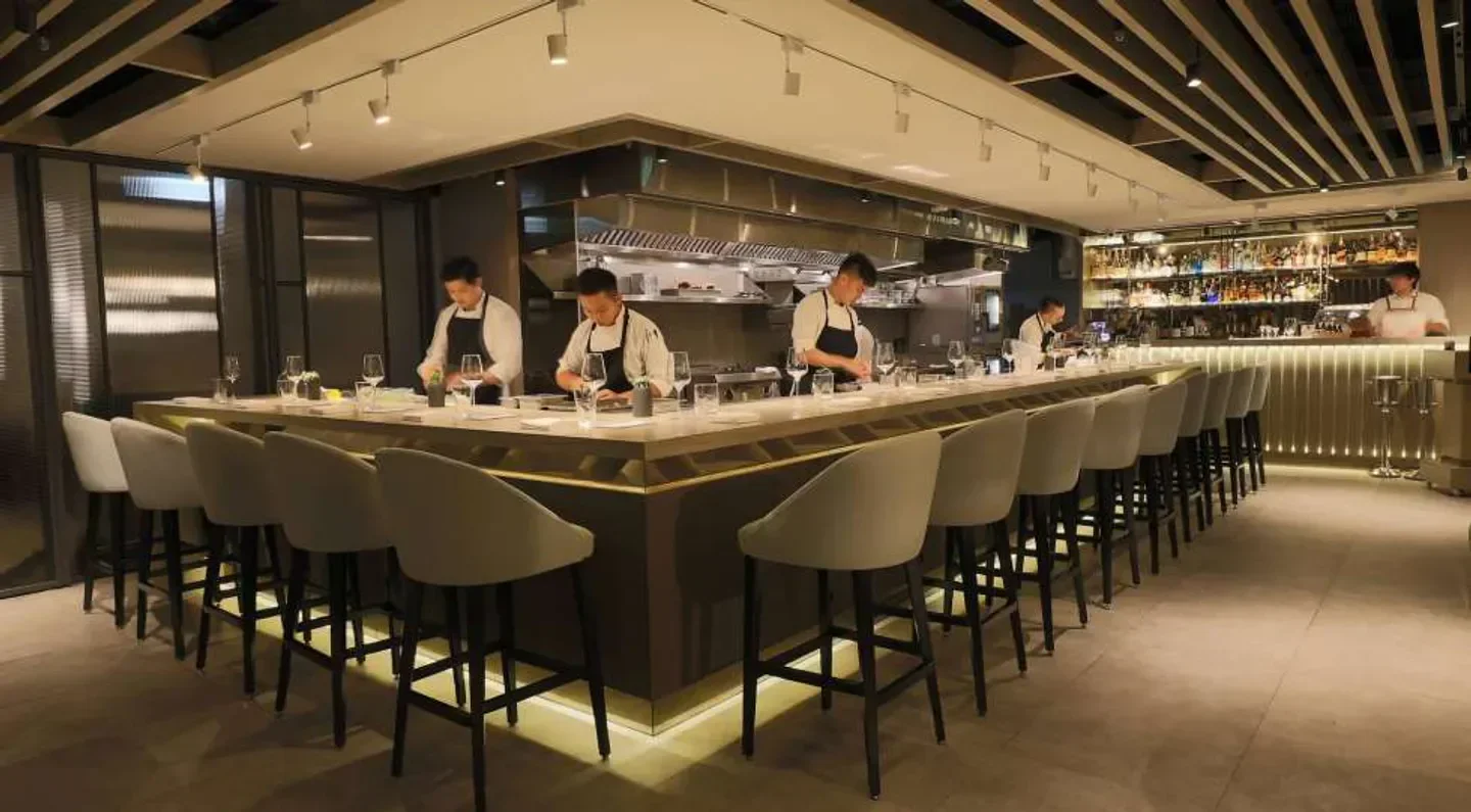 Chefs preparing meals at Impromptu by Paul Lee in Taipei, modern restaurant interior.