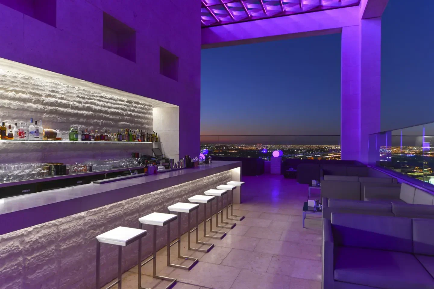 Rooftop bar at Infinity Rooftop Lounge in Doha, with a stylish design and city views.