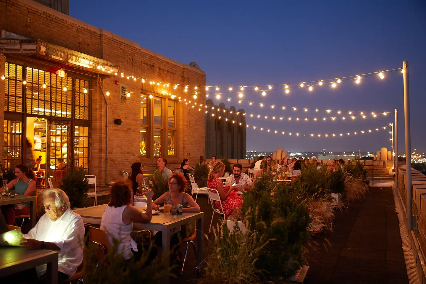 Rooftop dining at Irwin's in Philadelphia, with string lights and city views at dusk.