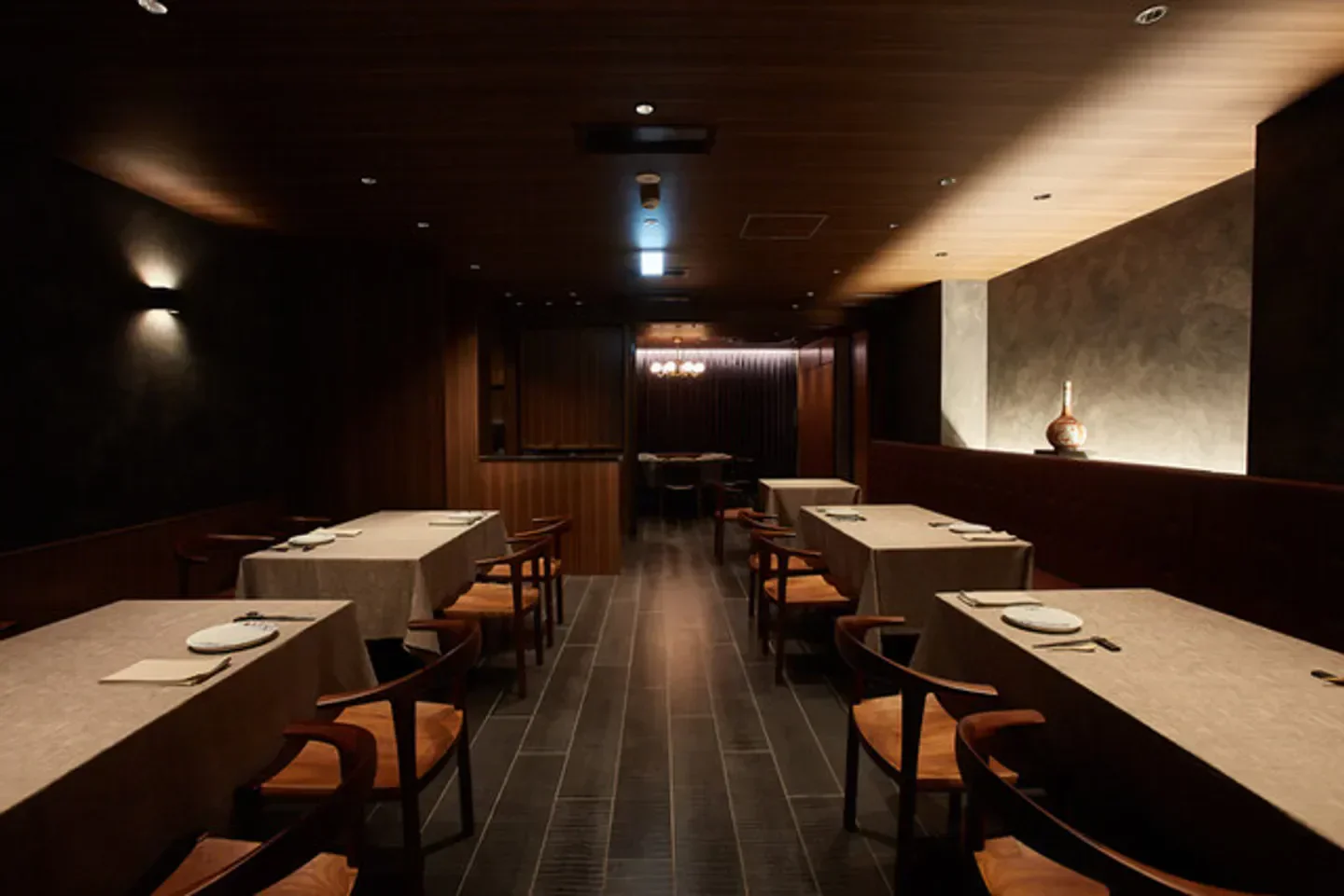 Interior of Itsuka restaurant in Tokyo, showcasing elegant dining tables and ambiance.
