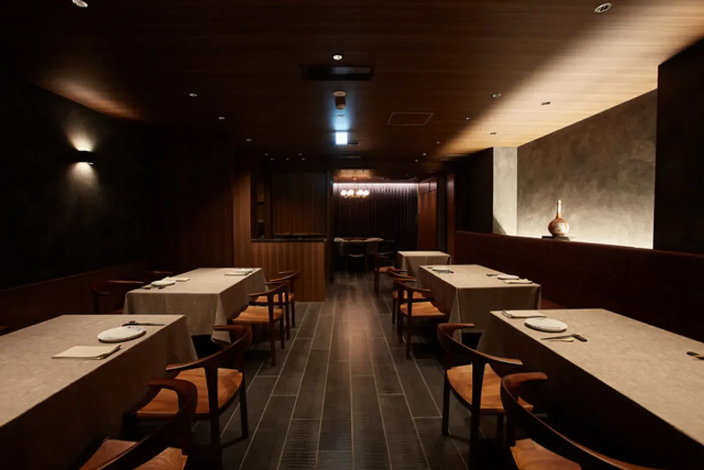 Interior of Itsuka restaurant in Tokyo, showcasing elegant dining tables and ambiance.