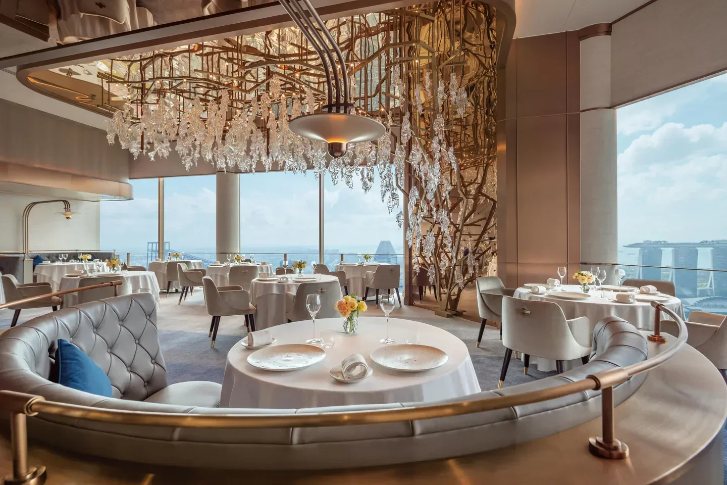 Elegant dining room at JAAN by Kirk Westaway, Singapore, with city skyline views.
