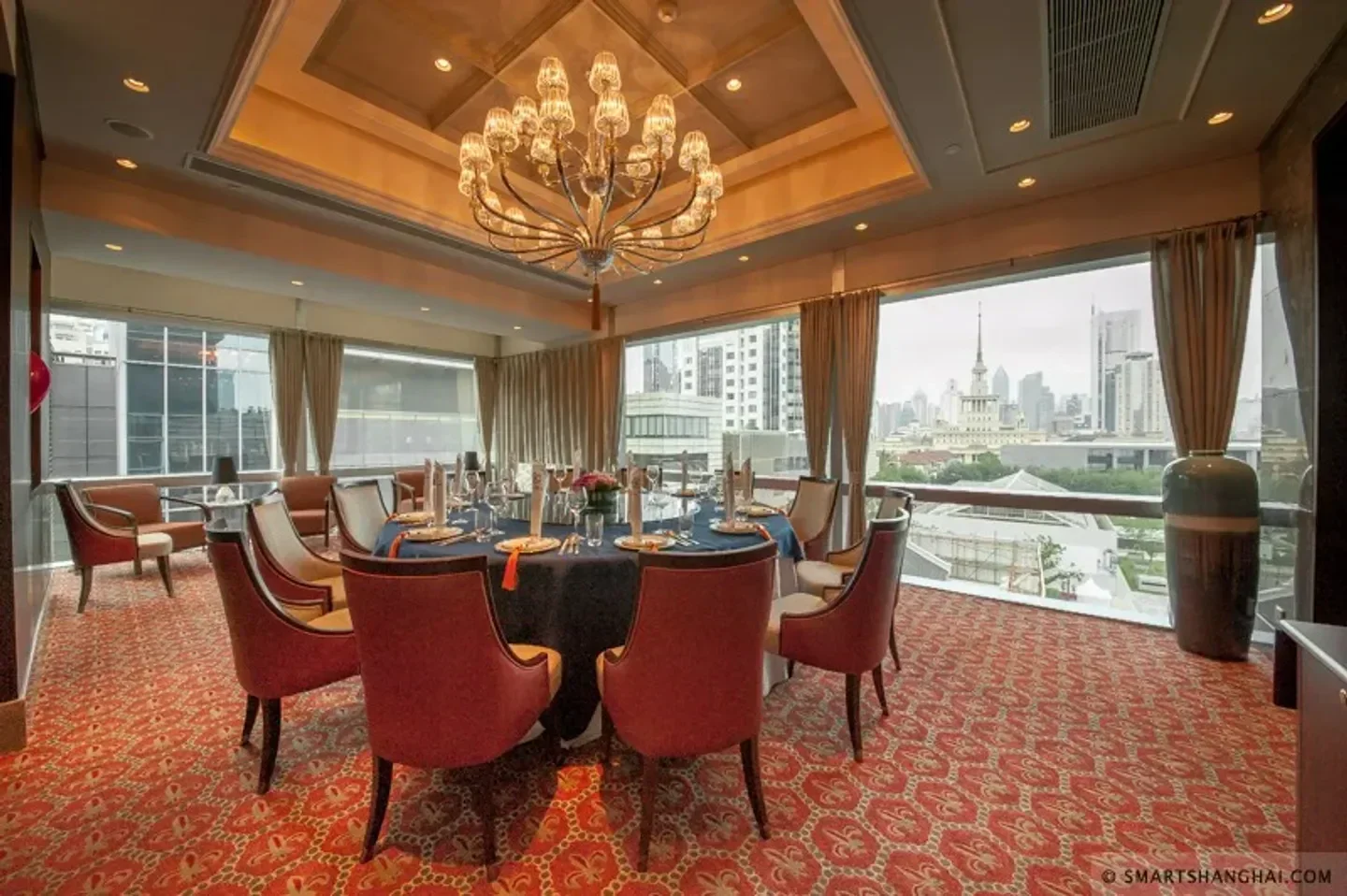 Elegant dining room at Jade Garden restaurant in Shanghai with city views.