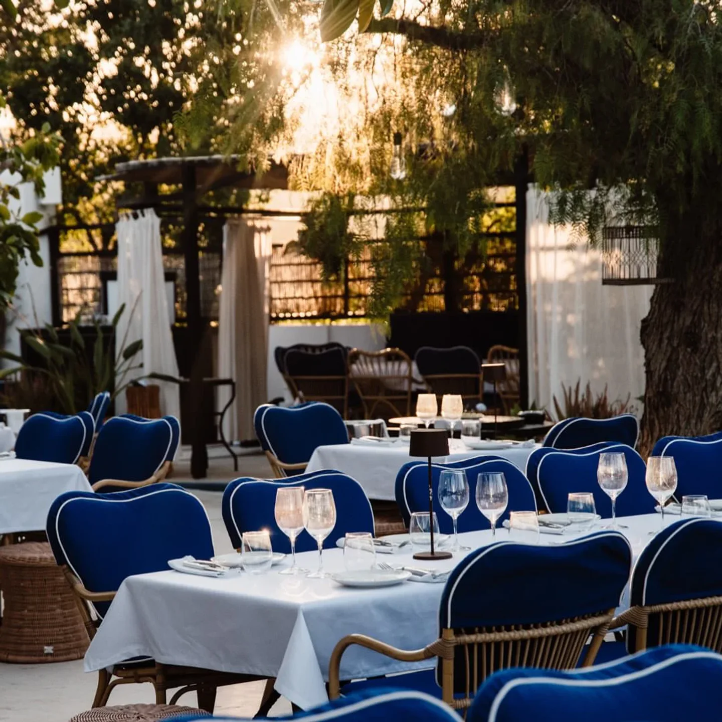 Charming outdoor seating at Jais restaurant in the city, bathed in warm sunset light.