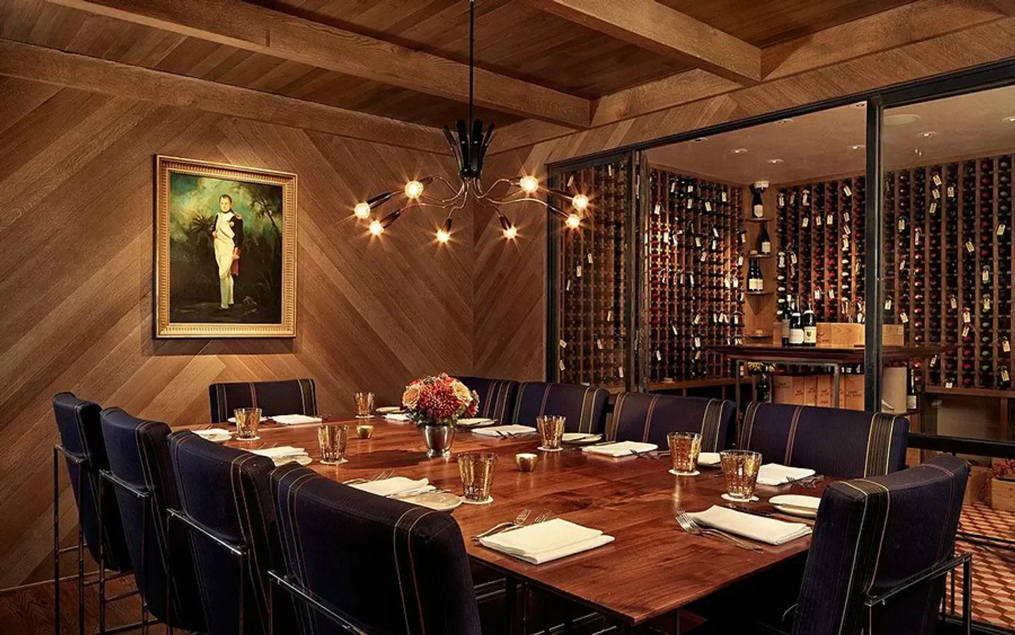 Elegant dining room at Jeffrey's in Austin, with a wine cellar visible