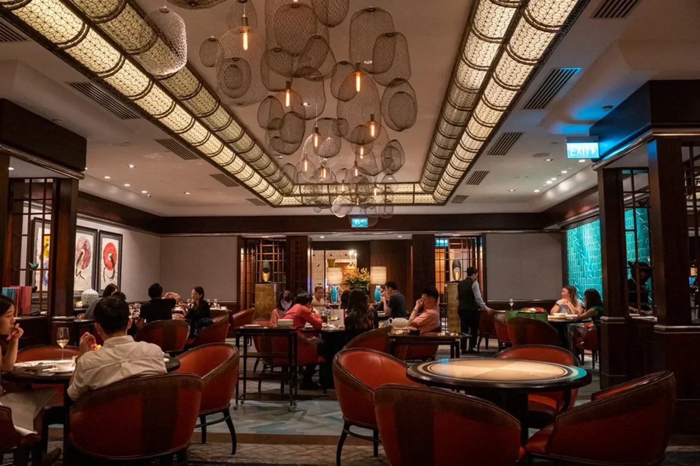 Interior of Jiang-Nan Chun restaurant in Singapore, with diners enjoying the ambiance.