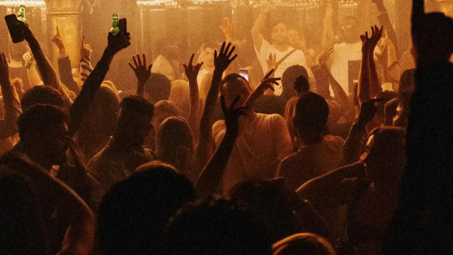 Energetic crowd at Jimmy Woo in Amsterdam, nightlife scene with raised hands
