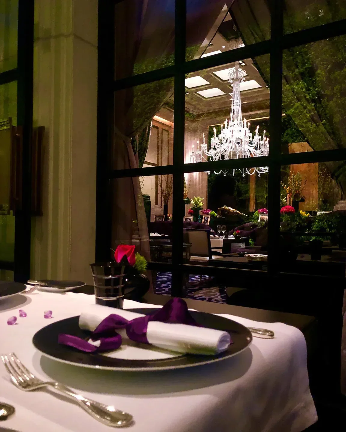 Elegant dining at Joël Robuchon in Las Vegas, with a view of a chandelier.