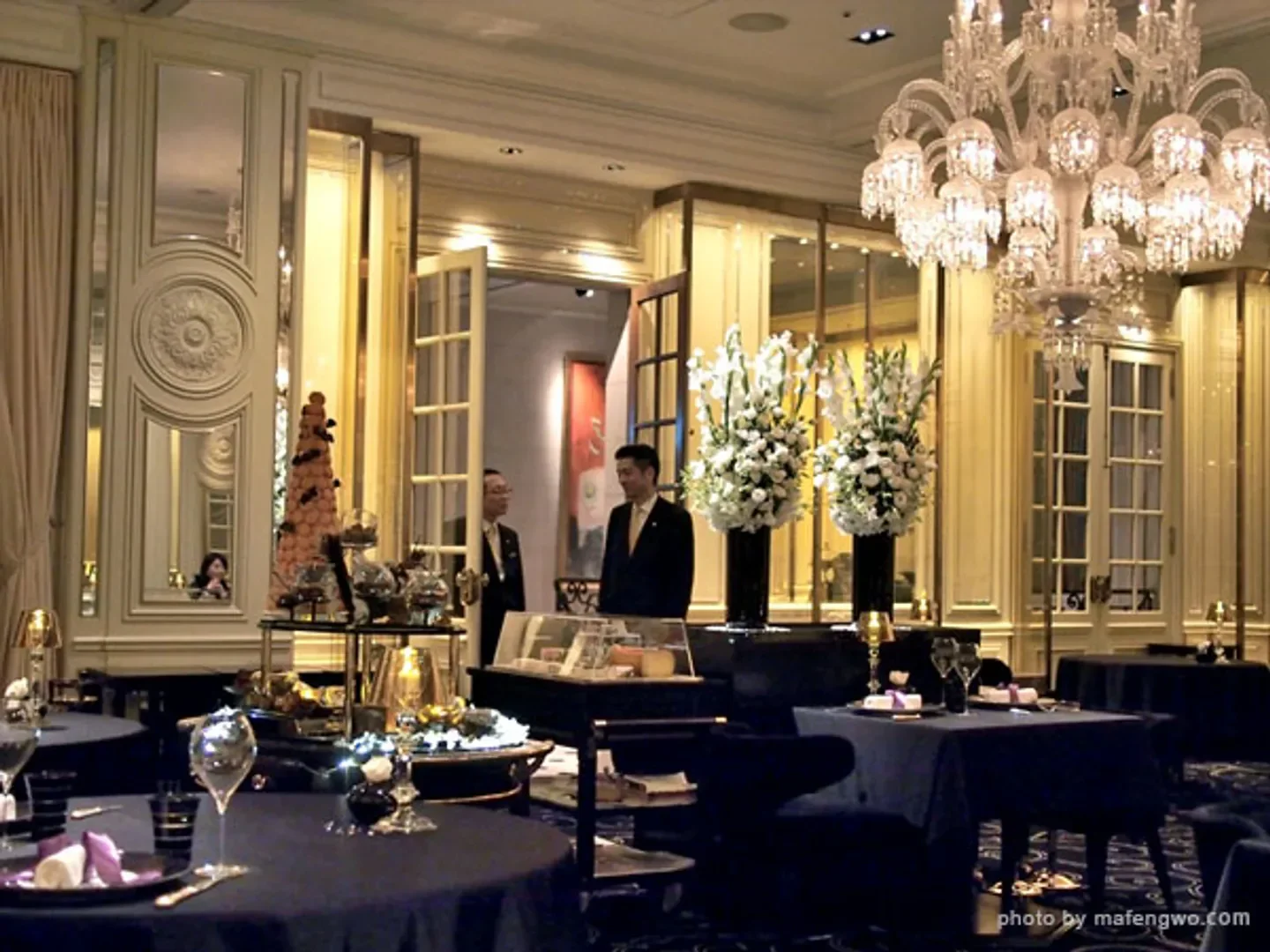 Elegant interior of Joël Robuchon Restaurant in Tokyo, with chandeliers and floral decor.
