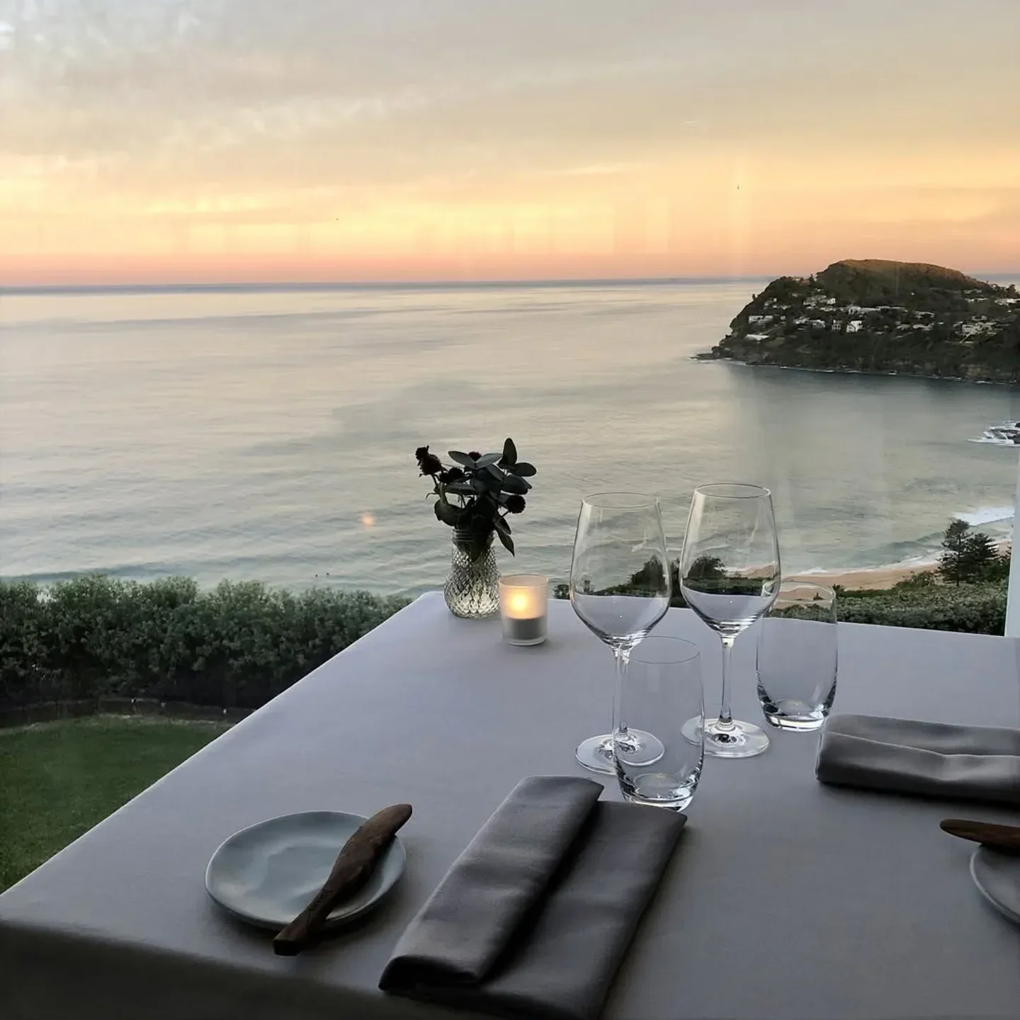 Table setting with ocean view at sunset, Jonah's Restaurant in Sydney