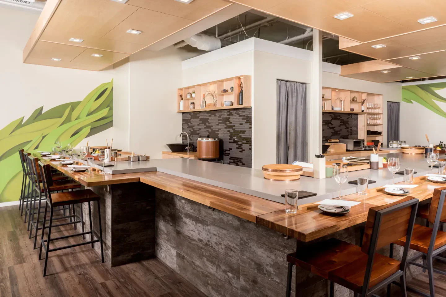 Interior of jū-ni restaurant in San Francisco with a modern wooden sushi bar.