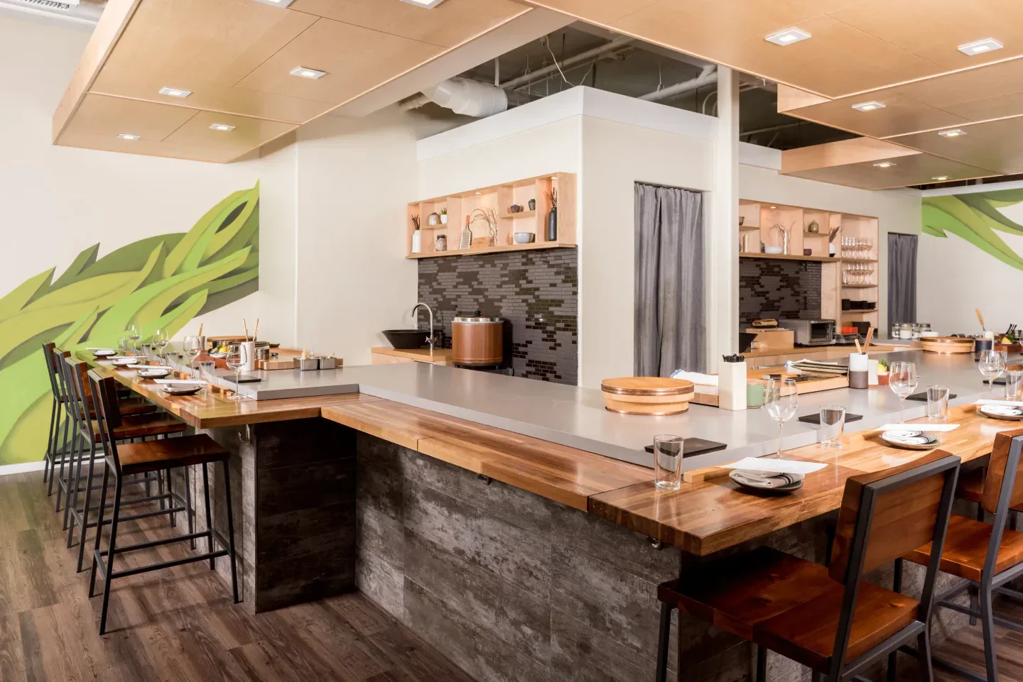 Interior of jū-ni restaurant in San Francisco with a modern wooden sushi bar.