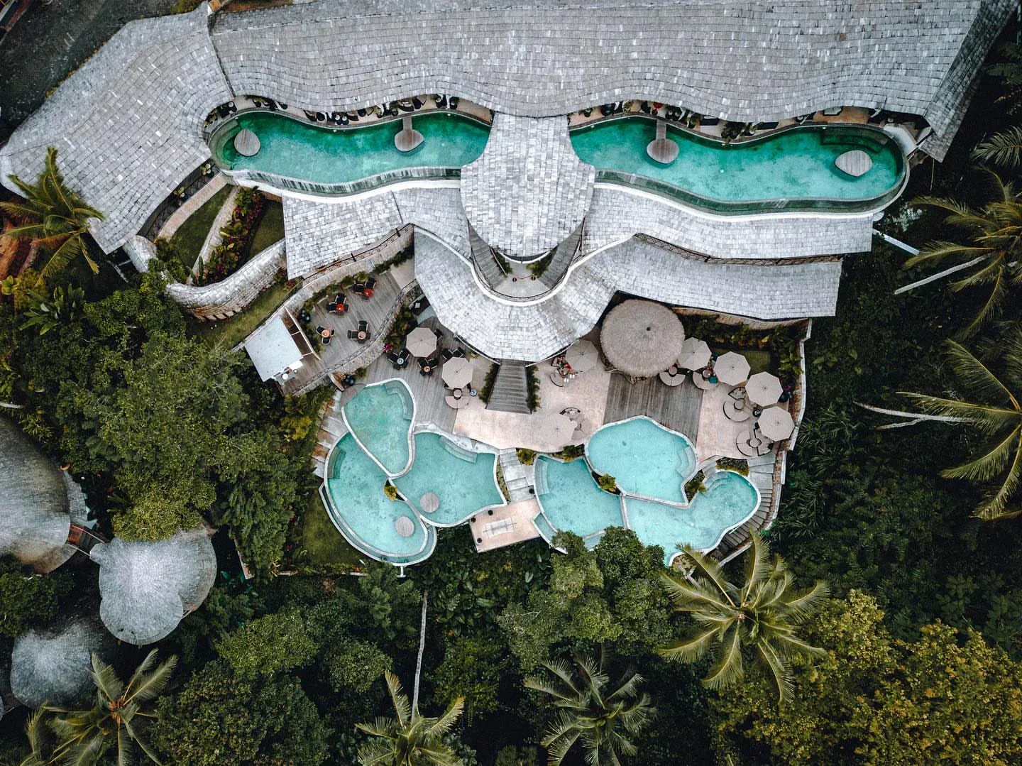 Aerial view of Kabana Ubud beach club in Bali with pools and tropical setting