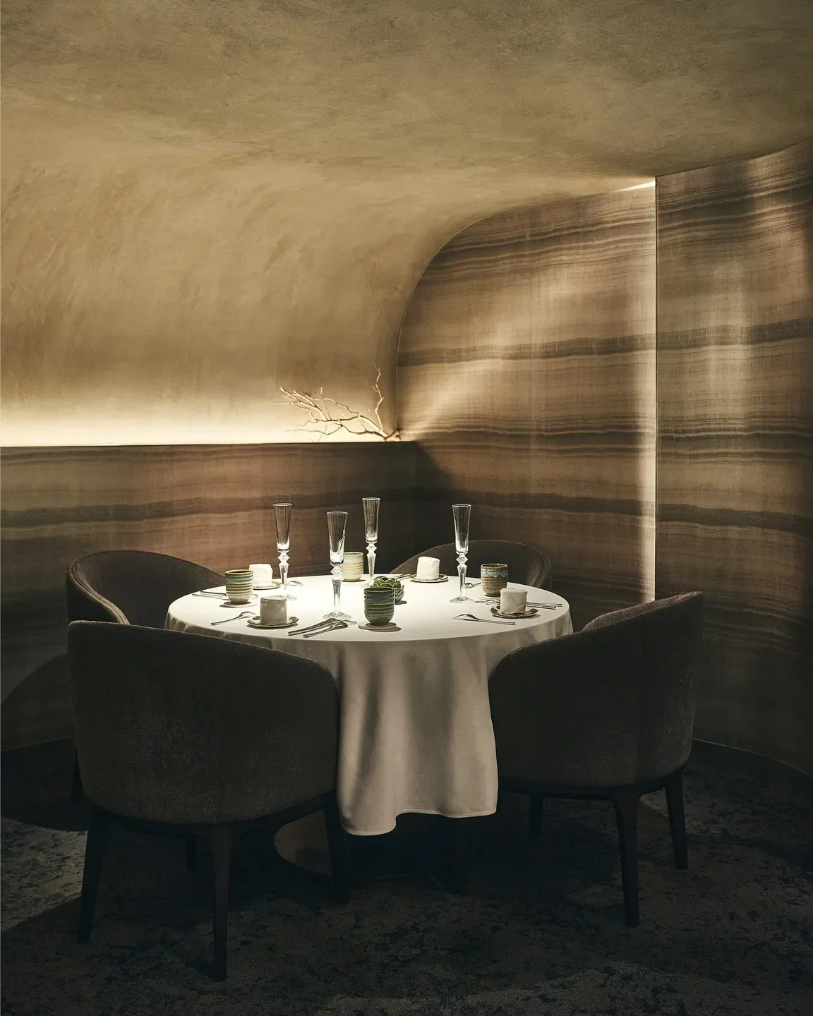 Elegant dining at KANG MINCHUL Restaurant in Seoul, featuring a round table setting with chairs.