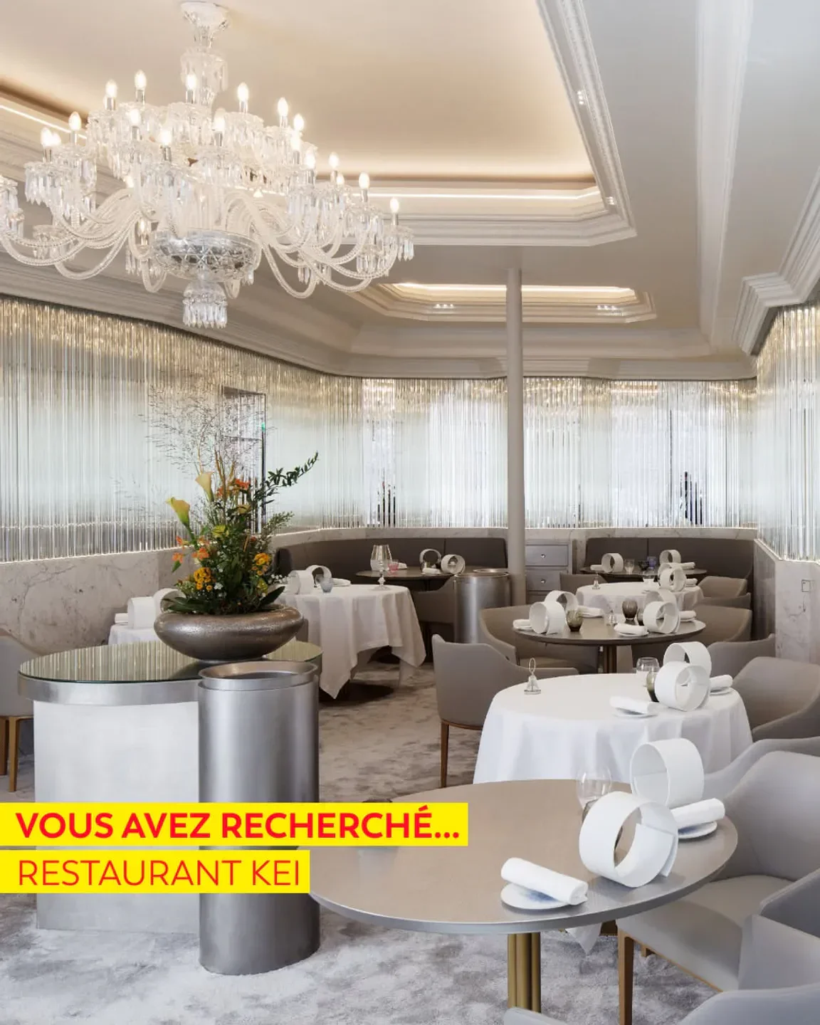 Elegant dining room interior at Kei restaurant in Paris, featuring a large chandelier.