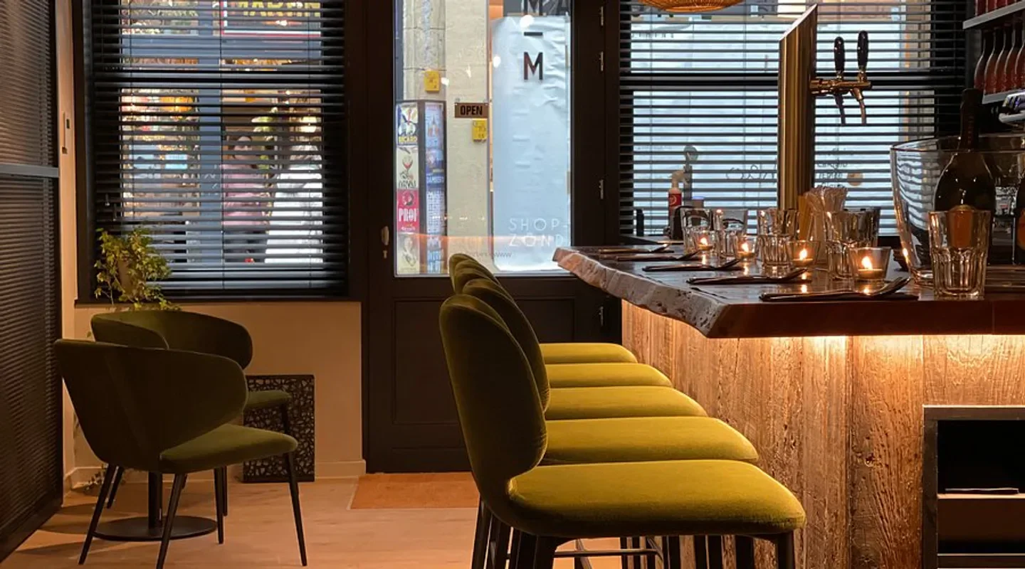 Cozy bar seating at Kin Khao restaurant in San Francisco with warm lighting and decor.