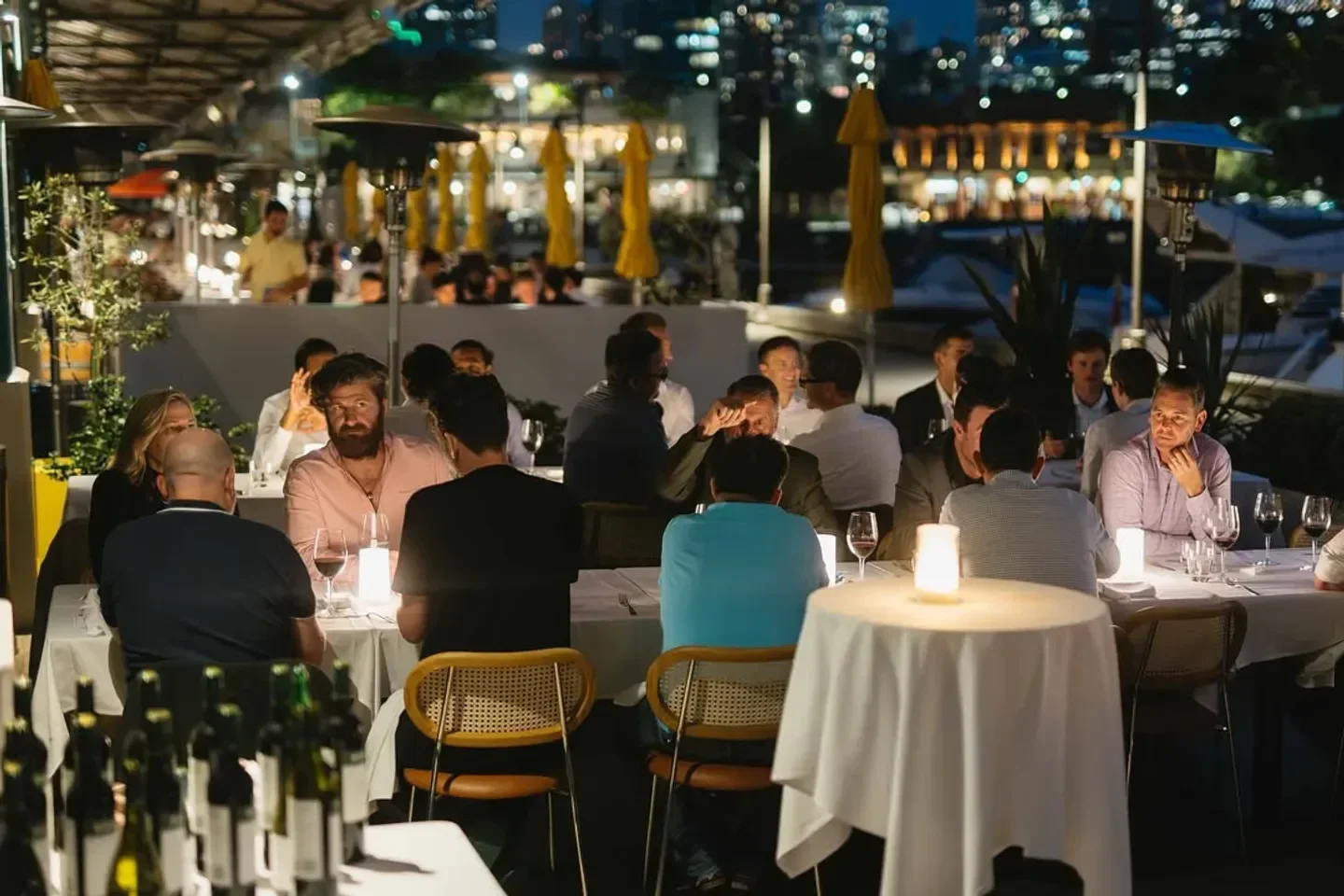 Outdoor dining at Kingsleys Sydney, featuring candlelit tables and a vibrant evening atmosphere.