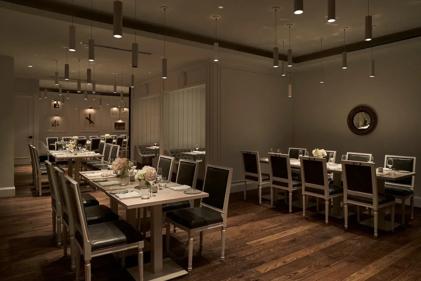 Elegant dining room interior at Kinship restaurant in Washington, DC with tables set.