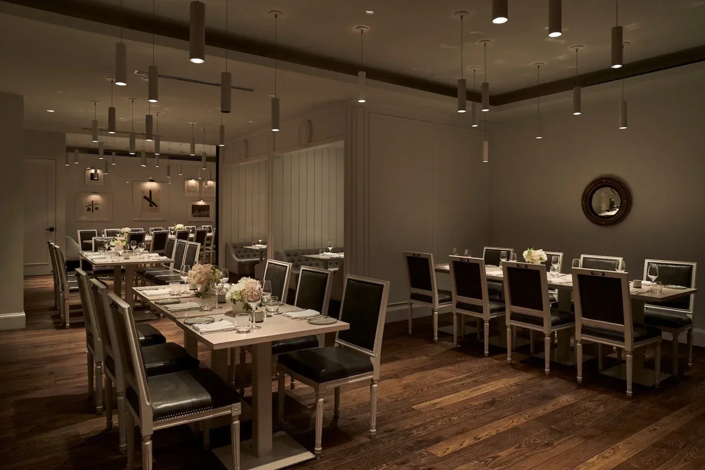 Elegant dining room interior at Kinship restaurant in Washington, DC with tables set.