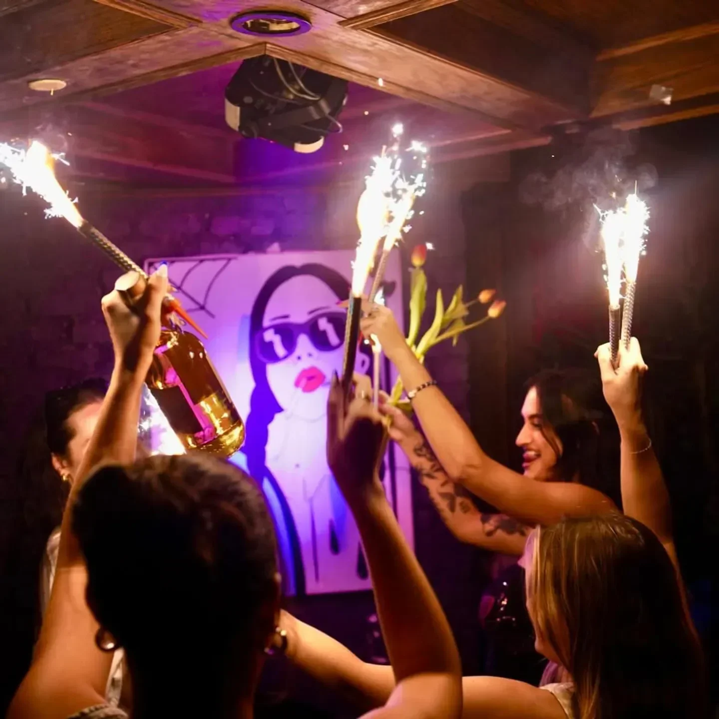 Sparkling celebration at Koo Koo Room in Atlanta. Nightclub scene with bottle sparklers.
