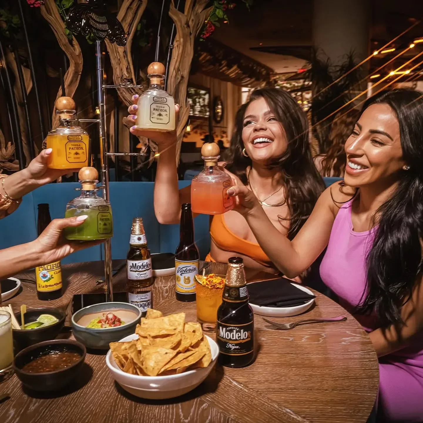 Friends enjoying tequila cocktails and appetizers at Kusa Nori in Las Vegas, a restaurant.