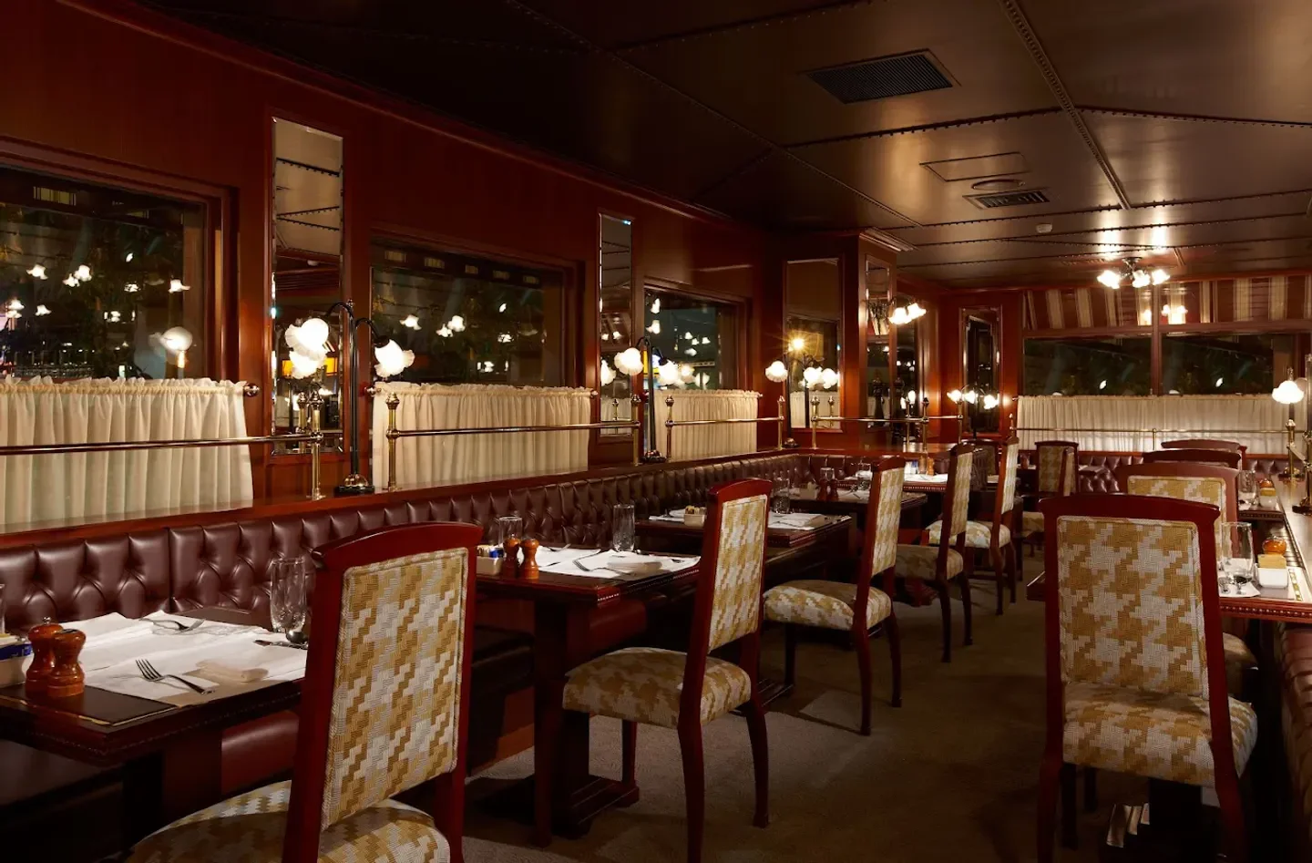 Cozy dining room at La Brasserie in Taipei with patterned chairs and tables set.