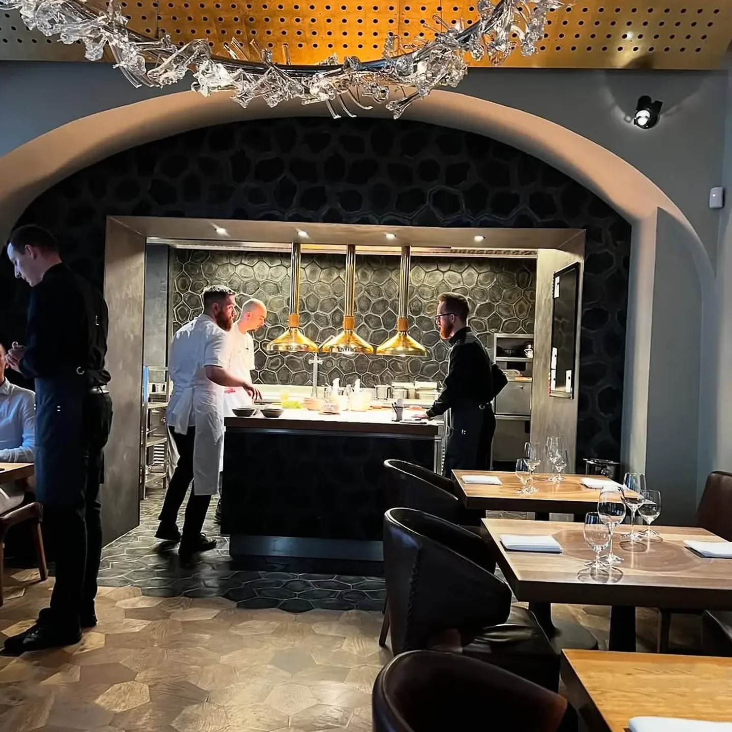 Chefs preparing a dish at La Degustation Bohême Bourgeoise in Prague restaurant.