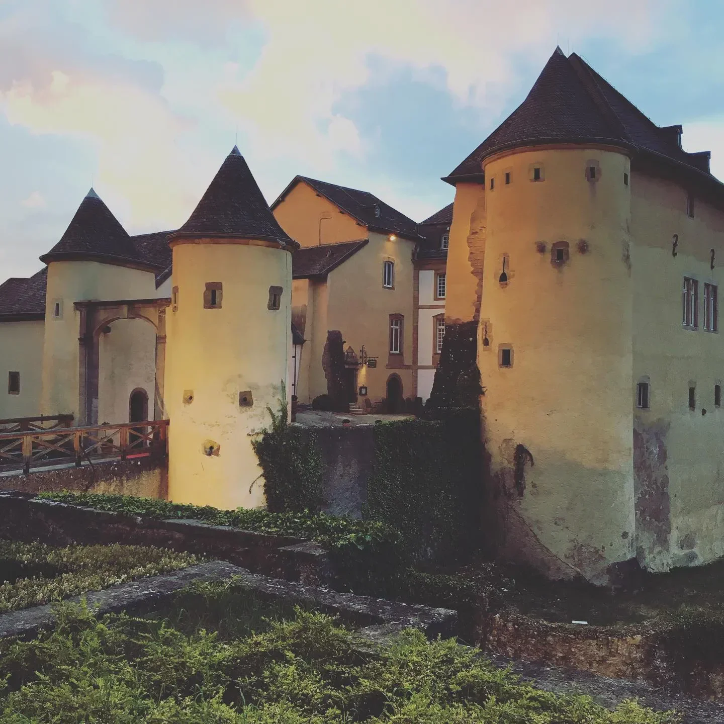 Exterior of La Distillerie in Luxembourg, featuring castle-like architecture and turrets.