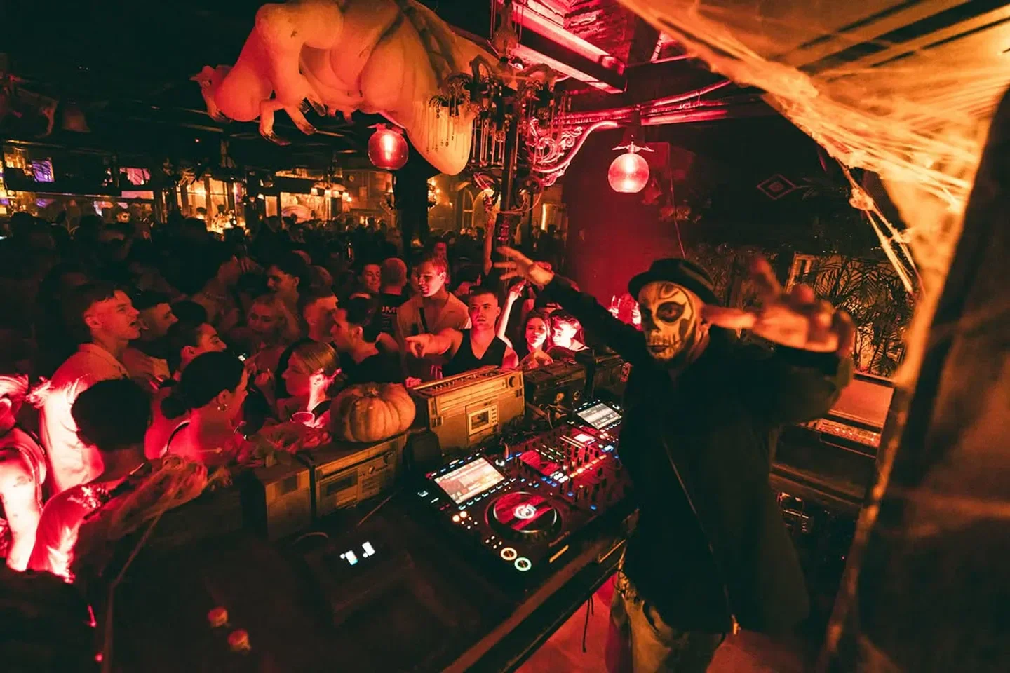 DJ at La Favela Bali nightclub, a vibrant scene with people and decorations.