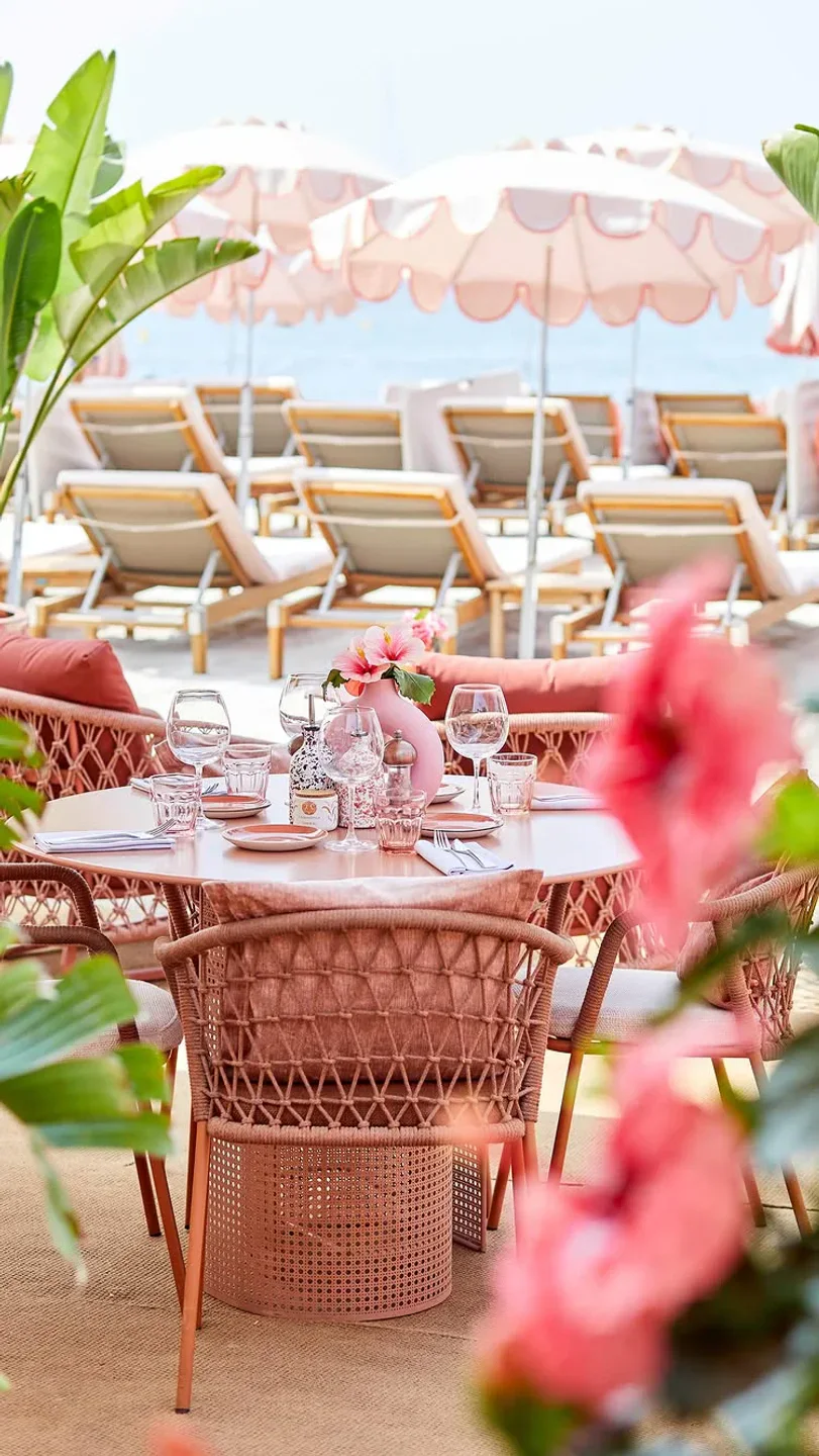 The chic outdoor dining area at La Mandala beach club, set for a meal by the sea.