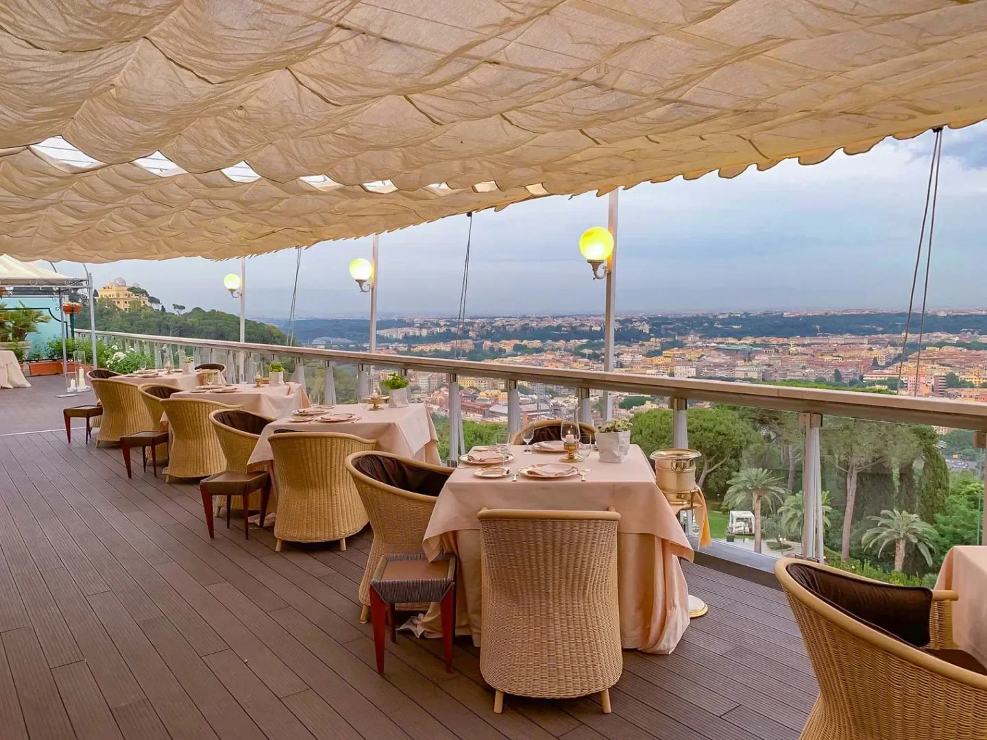 Dining terrace at La Pergola restaurant in Rome, overlooking the city's skyline.