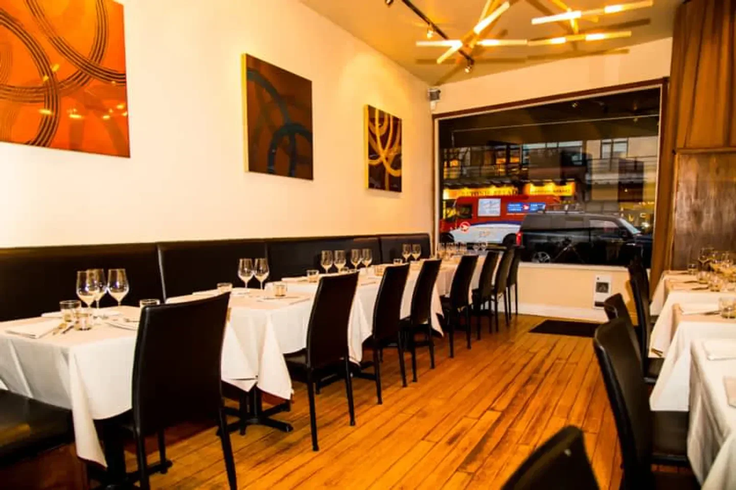 Interior of La Quercia restaurant in Vancouver, with tables set for dining