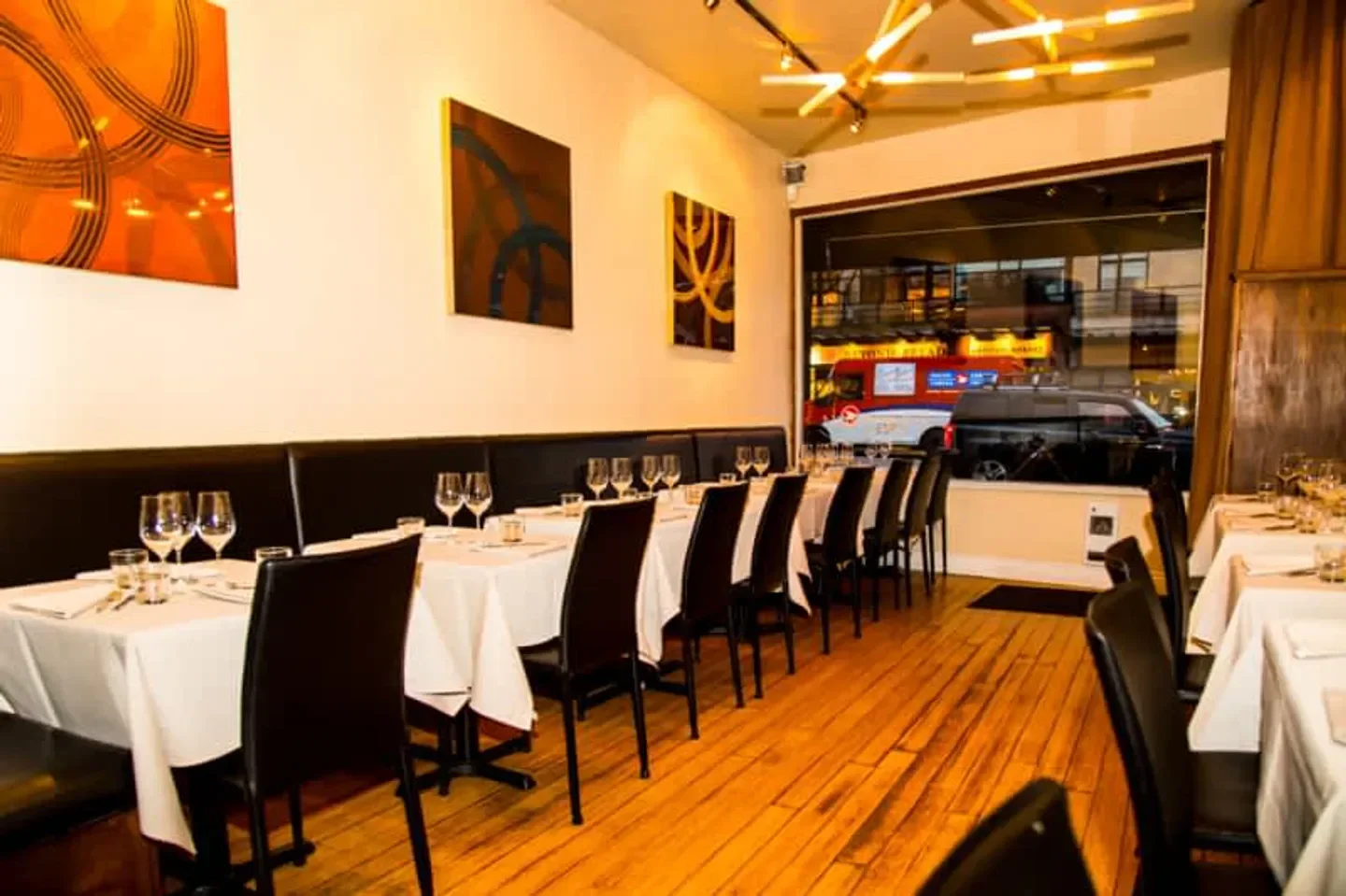 Interior of La Quercia restaurant in Vancouver, with tables set for dining
