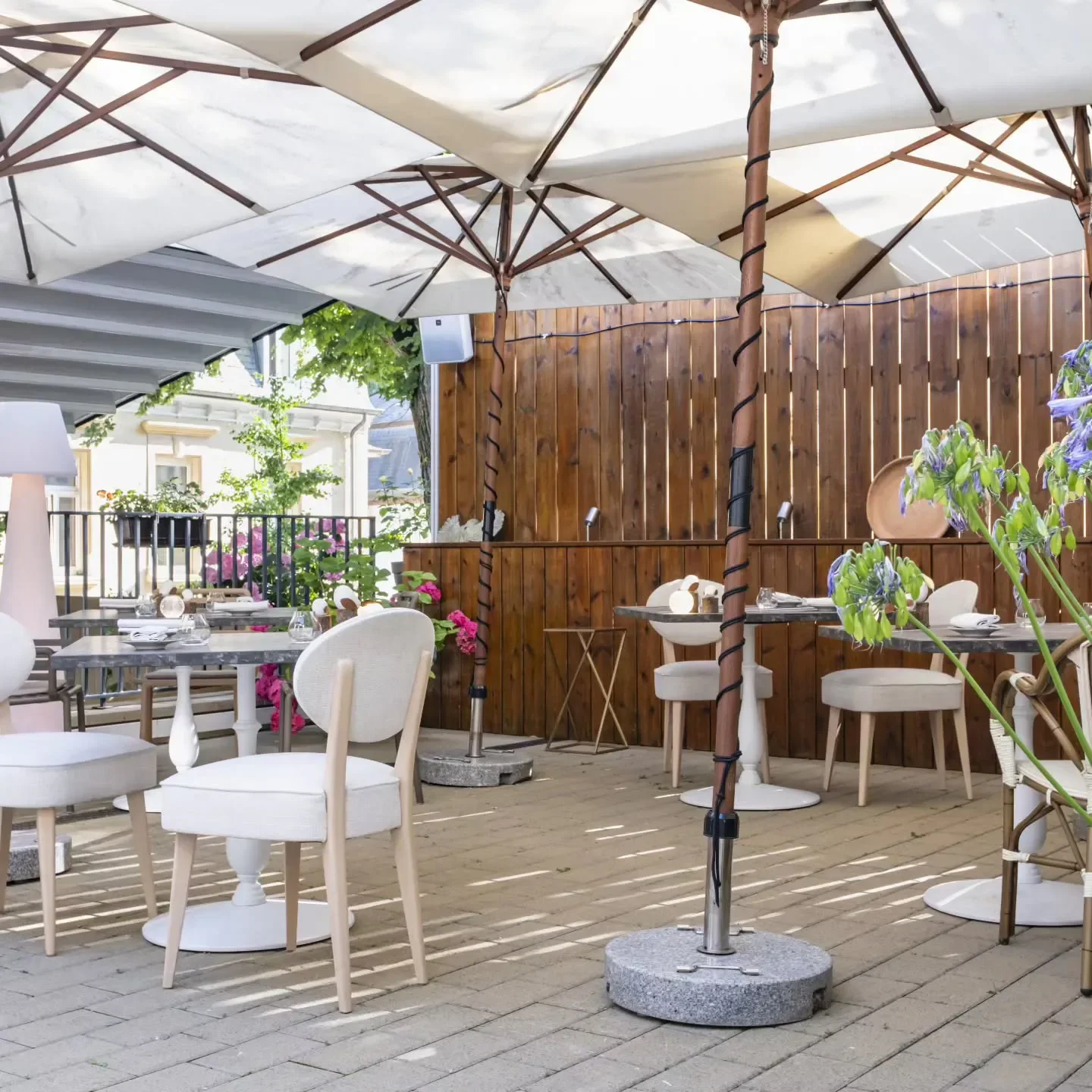 Outdoor seating at La Villa de Camille et Julien in Luxembourg, under umbrellas.