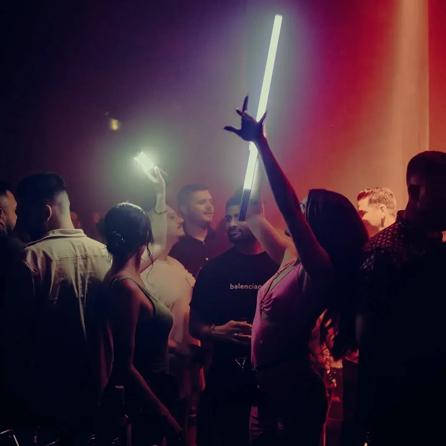 Energetic crowd at La Voute nightclub in Montreal, illuminated with neon lights and a lively atmosphere.