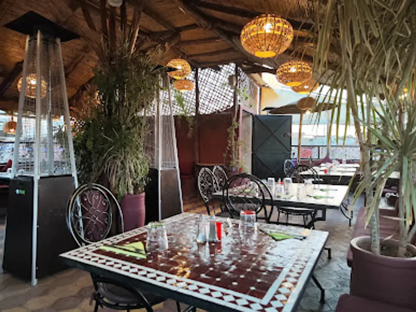 Cozy dining area at L'Amazigh Rooftop in Marrakech, with warm lighting and decor.