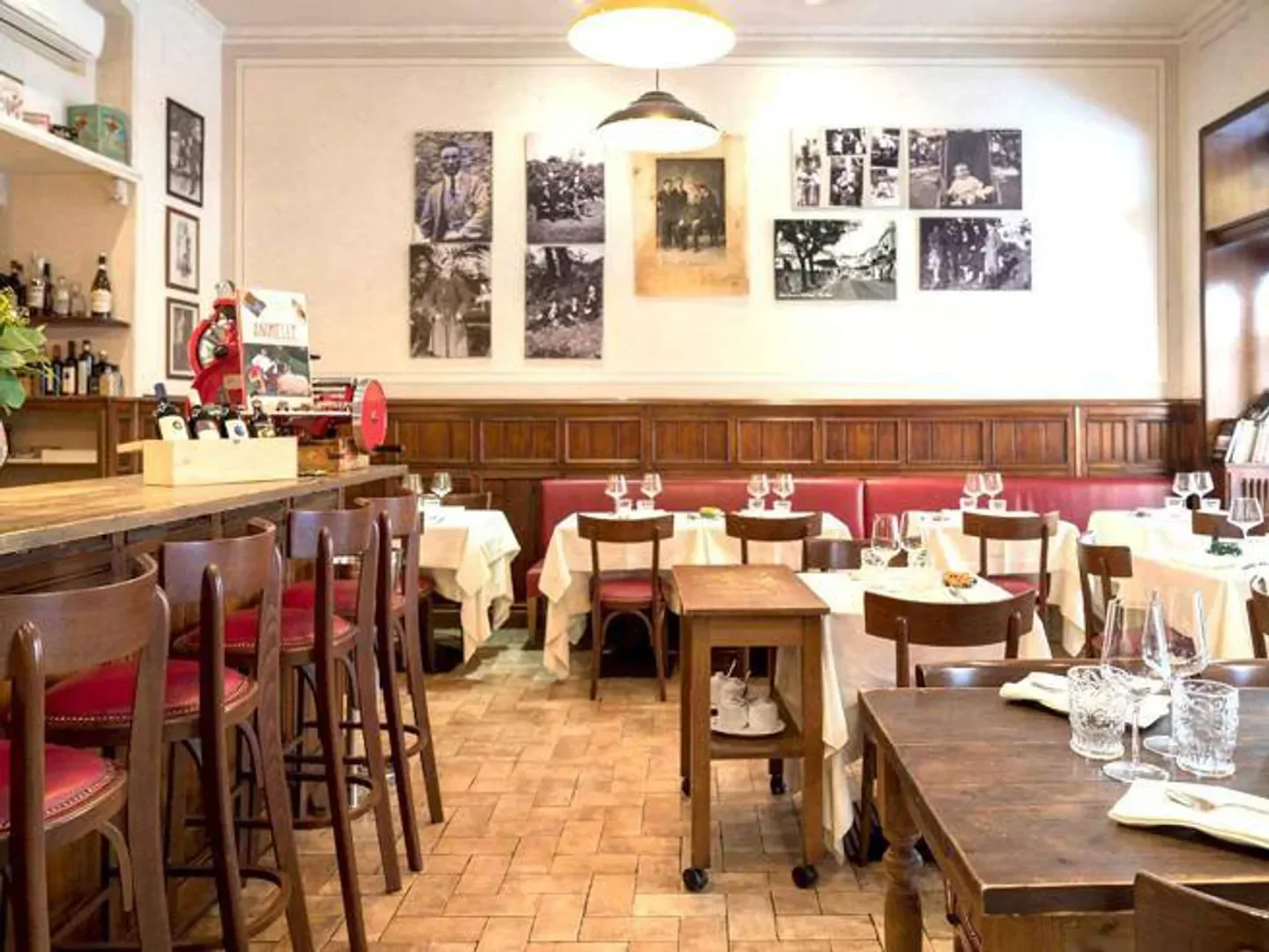Elegant dining area at L'Arcangelo Vino e Cucina in Rome, with tables and bar seating.