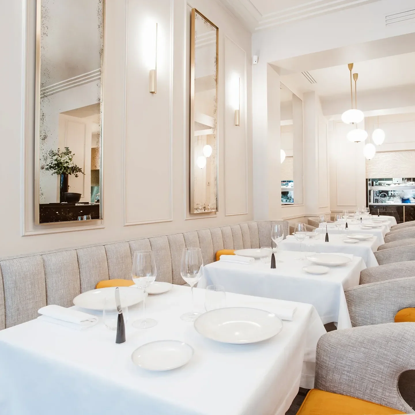 Elegant dining room interior at L'ArĂ´me restaurant in Paris, featuring stylish decor.