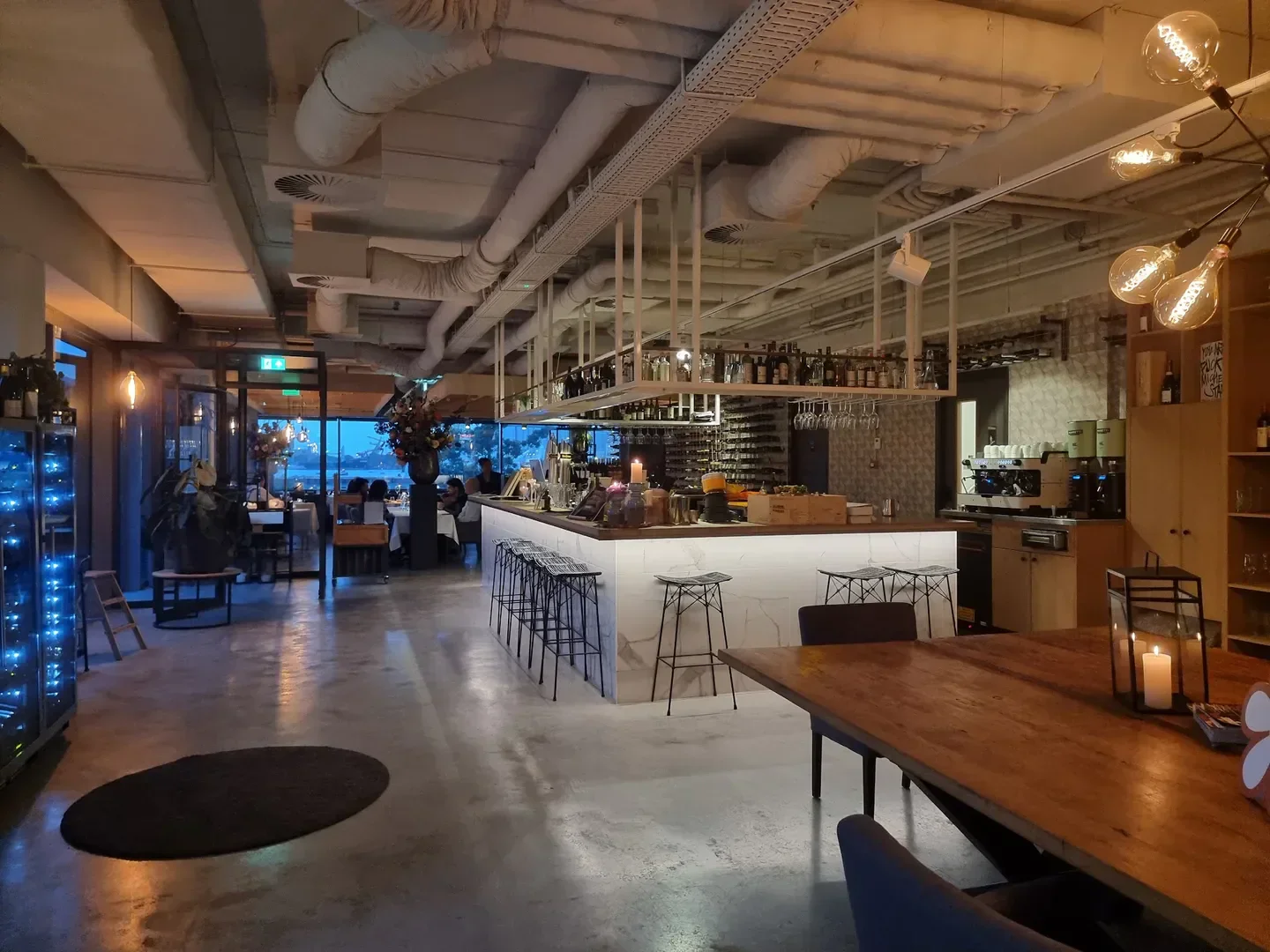 Interior of Lars Amsterdam restaurant in Amsterdam with bar, tables, and soft lighting.