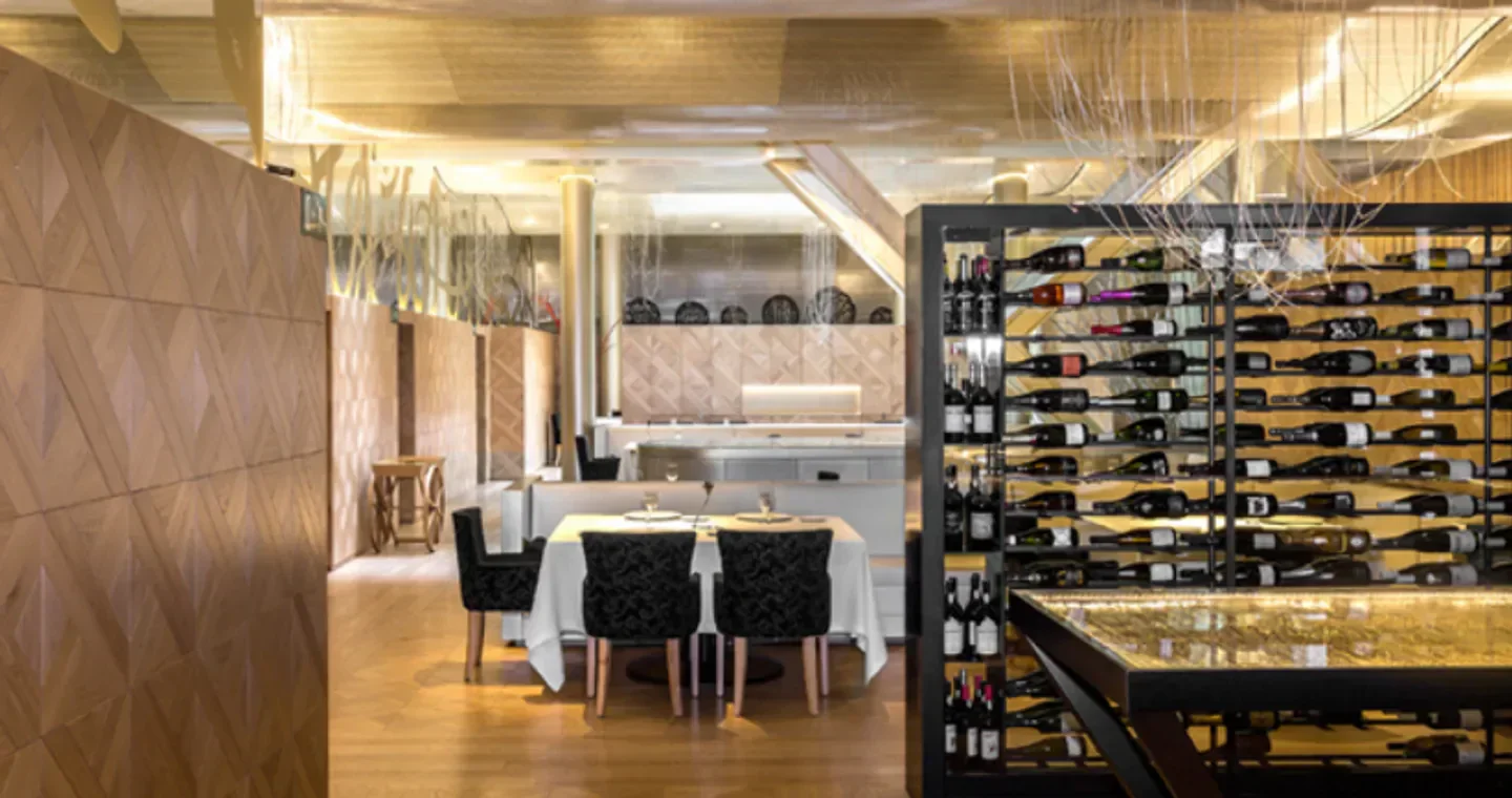 Interior of Lasarte restaurant in Barcelona, showcasing elegant dining area and wine selection.