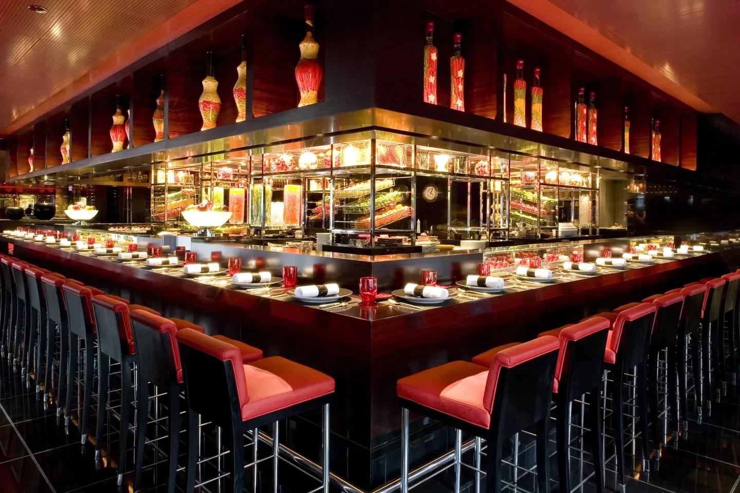 Interior of L'Atelier de Joël Robuchon in Hong Kong: elegant dining setting with bar seating.