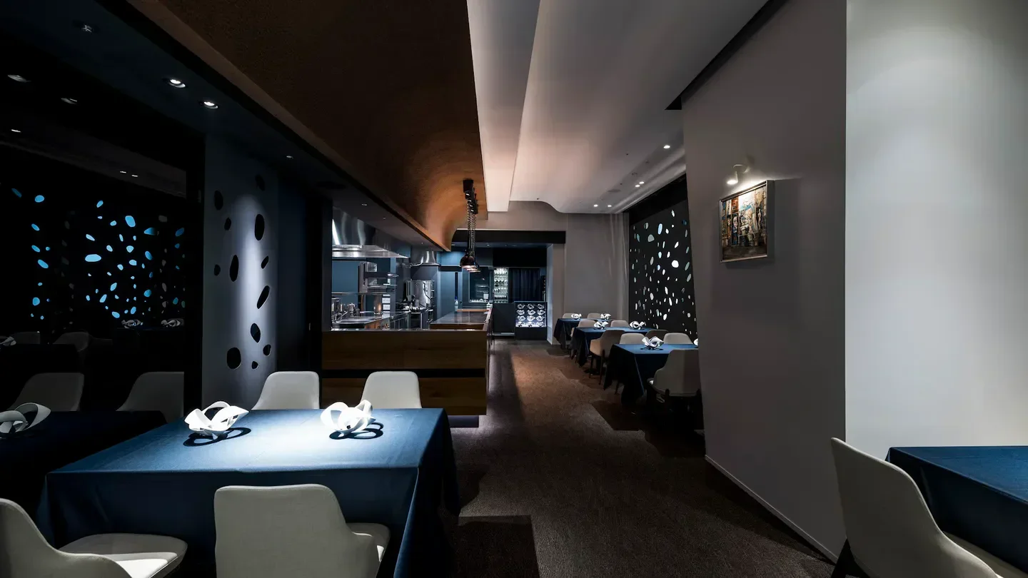 Interior of L'Aube restaurant in Tokyo, featuring stylish dining tables and decor.