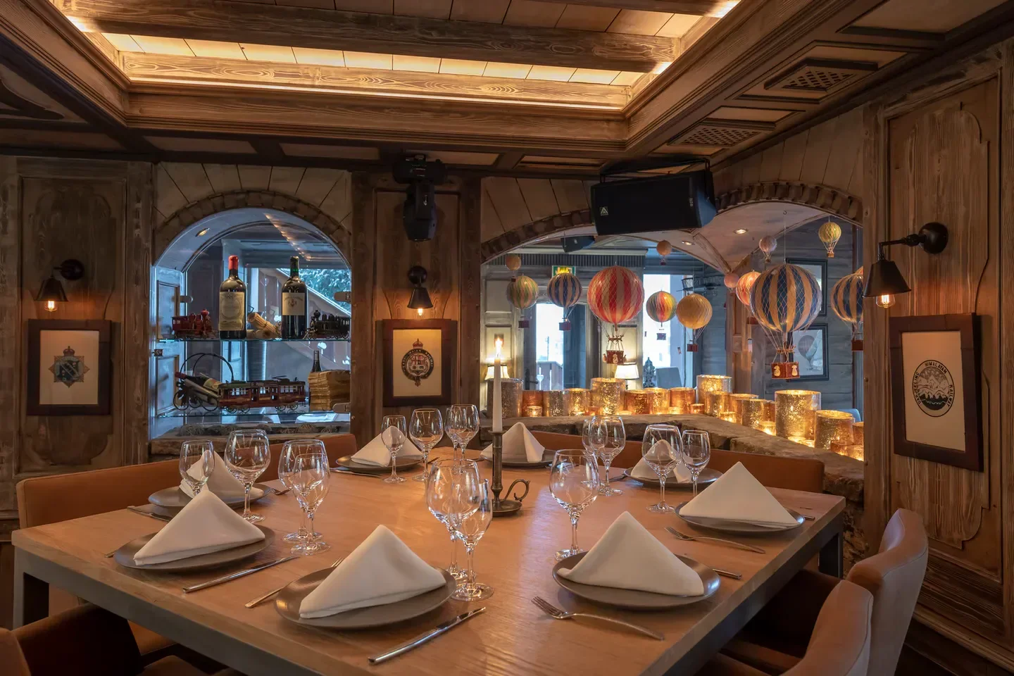 Cozy dining area at Le 80 restaurant in Meribel, featuring balloon decorations and warm lighting.