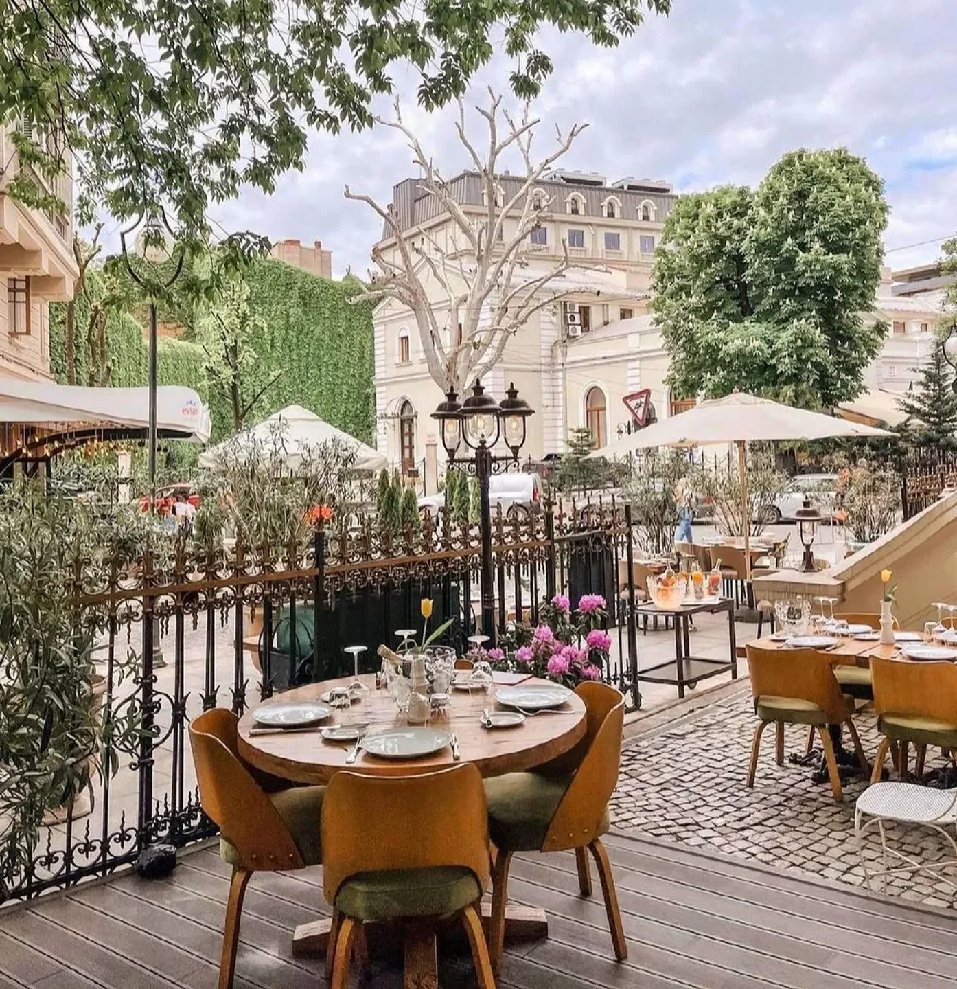 Outdoor dining at Le Bistrot Francais in Bucharest, featuring tables set for service.