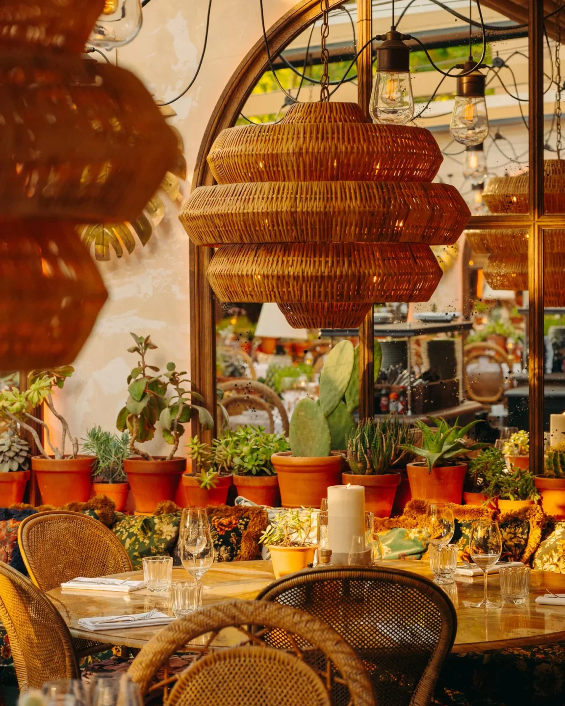 Bohemian ambiance at Le Cafe Saint-Tropez with rattan decor, plants, and table setting