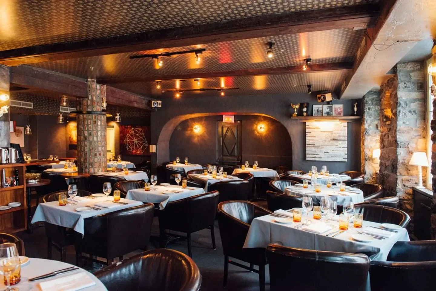 Interior of Le Club Chasse et Pèche restaurant in Montreal with elegant dining setting