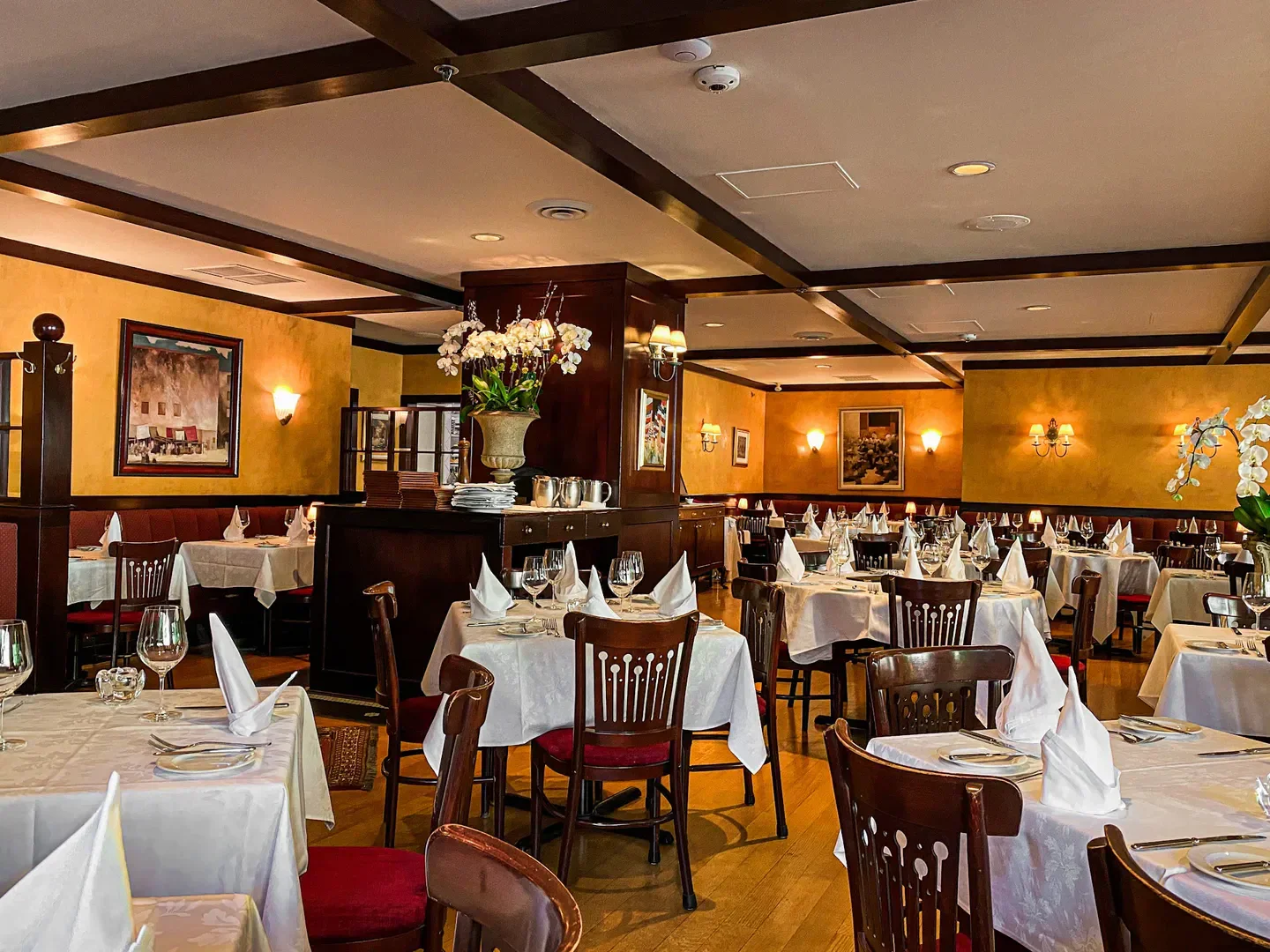 Elegant dining room interior at Le Crocodile in Vancouver, with tables set for service.